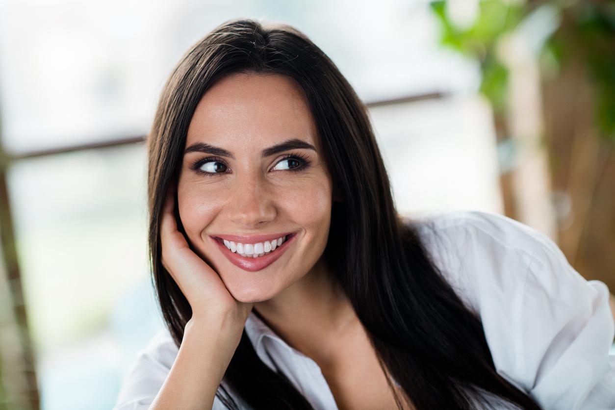 A woman with dark brown hair and a beautiful smile