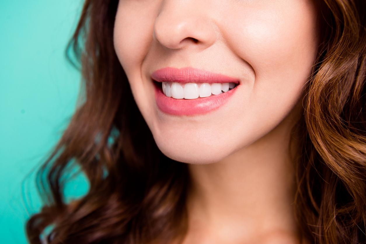 Up-close view of a woman's clean white smile after a dental cleaning